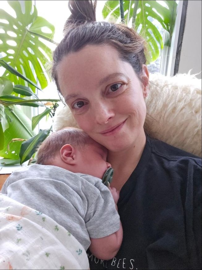 Melissa with her baby on the homestead